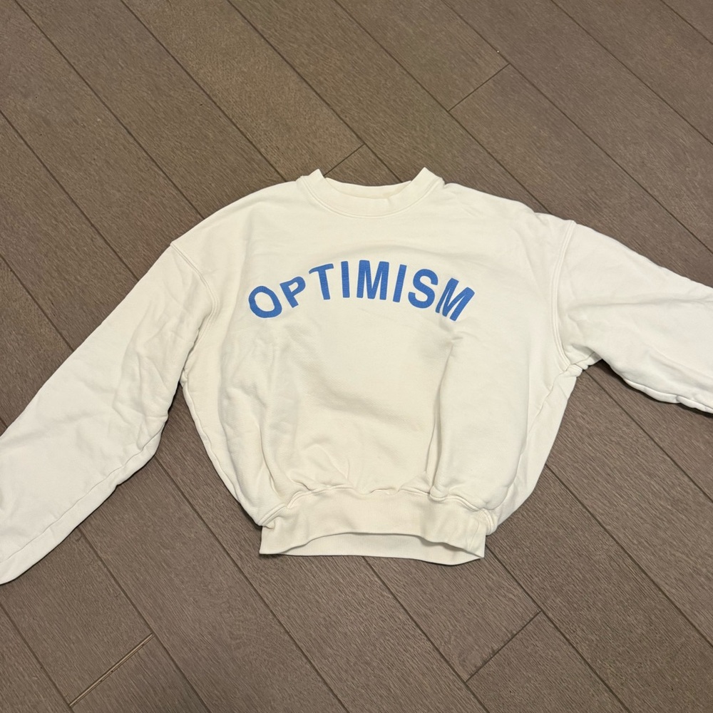 White Sweatshirt with Blue 'Optimism' Print